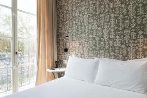 Hotel Tayko Sevilla客房内的一张或多张床位