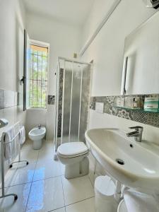 a bathroom with a sink and a toilet and a shower at Hotel Beau Rivage in Alassio +137 photos