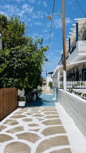 an empty street with trees and a building at Avra Studios in Elafonisos