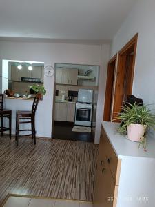 a kitchen and living room with a table and chairs at 3-Bedroom NewHome in Mostar