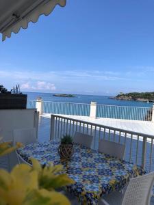 a table on a balcony with a view of the ocean at Vista Mare 1 in Marina di Camerota