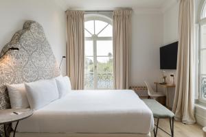 Hotel Tayko Sevilla客房内的一张或多张床位