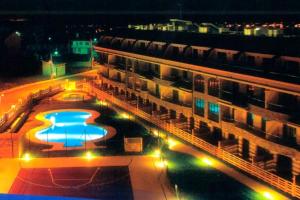arial view of a building with a swimming pool at night at Costa SPA Ático de lujo - Playa de las Catedrales in San Miguel de Reinante