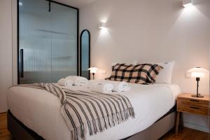 a bedroom with a bed with towels on it at Olivier Premium Apartments - Downtown Lisbon in Lisbon