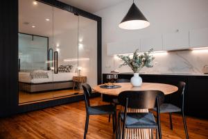 a dining room with a table and chairs and a bedroom at Olivier Premium Apartments - Downtown Lisbon in Lisbon