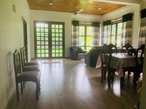 a living room with a table and chairs and a couch at Le Palme Ahangama in Ahangama
