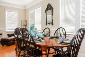 a dining room with a table with chairs and a mirror at Waterside Village Cottage 3220 by Pristine Properties Vacation Rentals in Mexico Beach