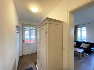 a hallway with a door to a living room at Haus Strandkiefer in Baabe +83 photos