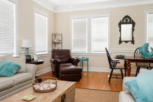 a living room with a couch and a chair at Waterside Village Cottage 3220 by Pristine Properties Vacation Rentals in Mexico Beach +88 photos