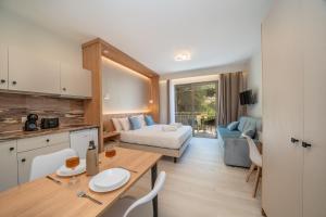 a room with a kitchen and a living room at Nicole Studios in Agia Effimia