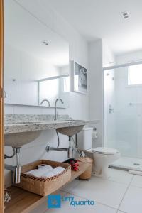 a bathroom with a sink and a toilet at Ponta de Inhambupe Residences in Baixio