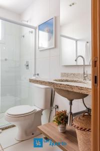 a bathroom with a toilet and a sink and a shower at Ponta de Inhambupe Residences in Baixio
