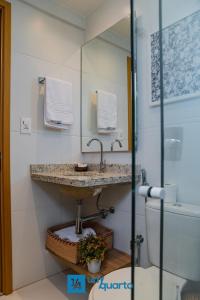 a bathroom with a sink and a toilet at Ponta de Inhambupe Residences in Baixio