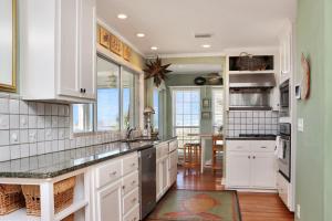 a kitchen with white cabinets and a counter top at White Pelican by Pristine Property Vacation Rentals in Indian Pass