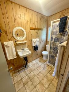 a wooden bathroom with a sink and a toilet at Chalets Bernatchez in Mont-saint-pierre