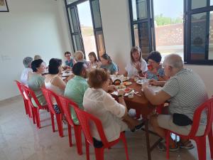 a group of people sitting around a table eating at hotel saanjh haveli in Orchha