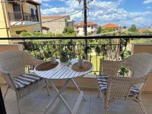a white table and chairs on a balcony at Sunnyside Suite Afytos in Afitos