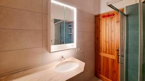 a bathroom with a sink and a mirror at Centro Residenziale Le Canne in San Teodoro +93 photos
