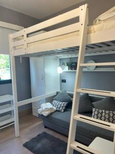 a bedroom with bunk beds with a couch and a bed at GARDEN HOUSE Madrid in Madrid