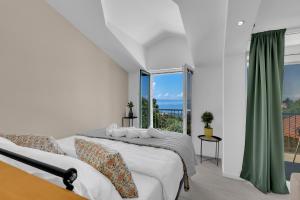a bedroom with a bed and a large window at Stonehouse Residence in Makarska +51 photos