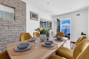 a dining room with a wooden table and chairs at Stonehouse Residence in Makarska