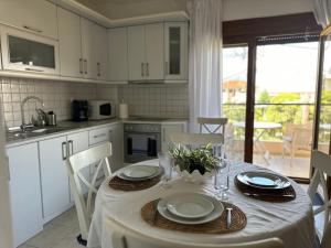 a kitchen with a table with a white table cloth on it at Sunnyside Suite Afytos in Afitos