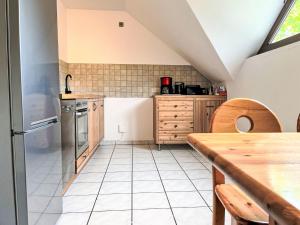 a kitchen with a table and a counter top at Apartment Ferienapartments Adenau-4 by Interhome in Adenau