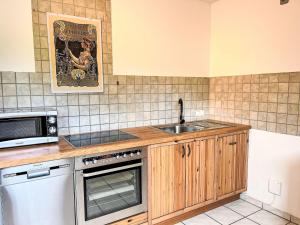 a kitchen with a sink and a microwave at Apartment Ferienapartments Adenau-4 by Interhome in Adenau