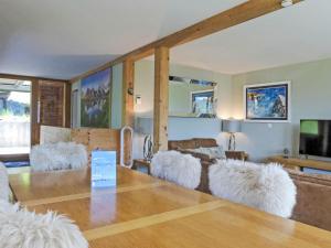 a living room with a couch and a table at Apartment Roossi Apt- 1 by Interhome in Wengen +24 photos