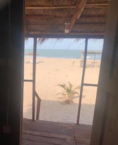 a view of the beach from a window of a beach at Bosofet Beach and Creek Lodge in Sanyang