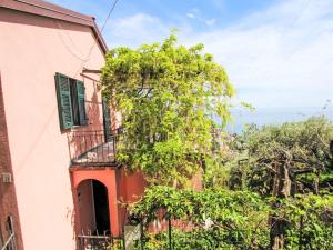a tree in front of a building with a balcony at Holiday Home Italo by Interhome in Zoagli