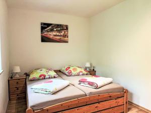 a bedroom with two twin beds and a picture on the wall at Apartment Ferienapartments Adenau-3 by Interhome in Adenau