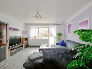 a living room with a couch and a tv at Holiday Home Ferienhaus Born by Interhome in Schieder-Schwalenberg