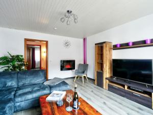 a living room with a couch and a tv at Holiday Home Ferienhaus Born by Interhome in Schieder-Schwalenberg