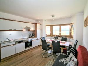 a kitchen and living room with a table and chairs at Apartment Diesinghof by Interhome in Weerberg