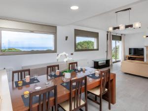 a dining room and living room with a table and chairs at Villa Palmbeach by Interhome in Lloret de Mar