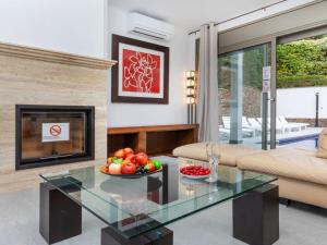 a living room with a glass table with a bowl of fruit at Villa Palmbeach by Interhome in Lloret de Mar
