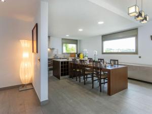 a dining room and kitchen with a table and chairs at Villa Palmbeach by Interhome in Lloret de Mar