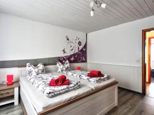 two beds in a room with red pillows on them at Apartment Born 1 by Interhome in Schieder-Schwalenberg