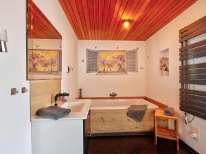 a bathroom with a tub and a sink at Apartment Born 1 by Interhome in Schieder-Schwalenberg