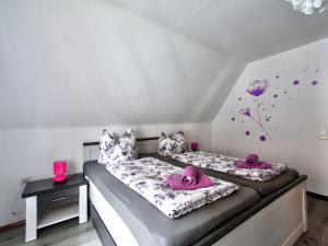two beds in a room with pink hats on them at Apartment Born 3 by Interhome in Schieder-Schwalenberg