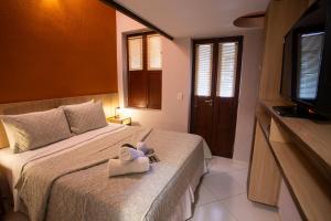 a bedroom with a bed with a towel on it at Casa Conceição in Fernando de Noronha