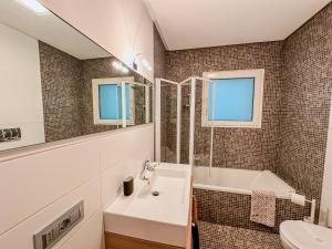 a bathroom with a sink and a tub and a toilet at Modern Luxury Loft Porta Nuova - Parcheggio Privato in Turin
