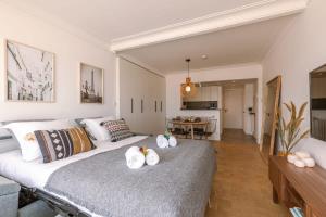 een slaapkamer met een groot bed en handdoeken bij Stunning studio with sea-view and terrace in Knokke-Heist