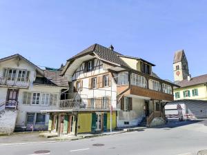an old building with a clock tower on a street at Apartment Bieri-Haus by Interhome in Unterseen