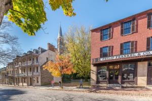 an old brick building on a street with a church at La Soledad Lavender Farm and Guesthouse in Harpers Ferry