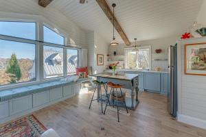 a kitchen with a counter and a table and some windows at La Soledad Lavender Farm and Guesthouse in Harpers Ferry +13 photos