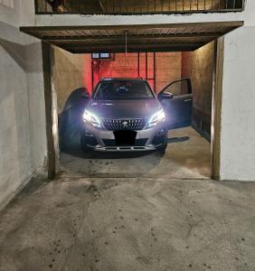 a car parked in a garage with its headlights on at Appartamento Alpi Retiche Sondrio in Sondrio