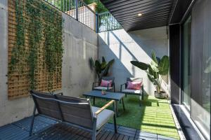 an outdoor patio with two chairs and a table at Spacious 3BDR Sleeps 6 with Patio By Little Italy! in Toronto