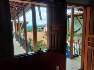 a room with a view of a balcony at Chapada Backpackers Hostel Agência in Lençóis